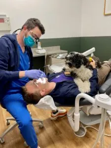 dentist with patient and emotional support dog