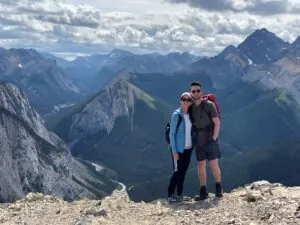 two hikers with mountains in the background