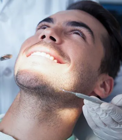 man receiving cosmetic dental care at Uptown Family Dental