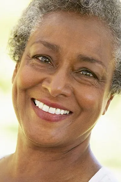 woman smiling with her new dentures from Uptown Family Dental