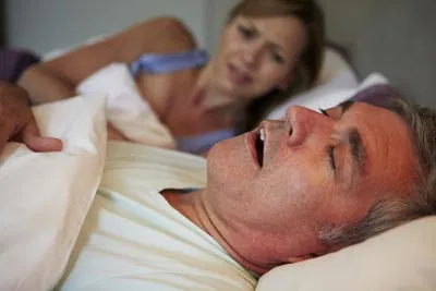 woman awake at night due to her husband's snoring