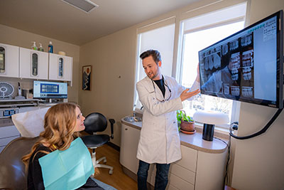 Dr Moody speaking with a patient about dental crown options at uptown family dental.