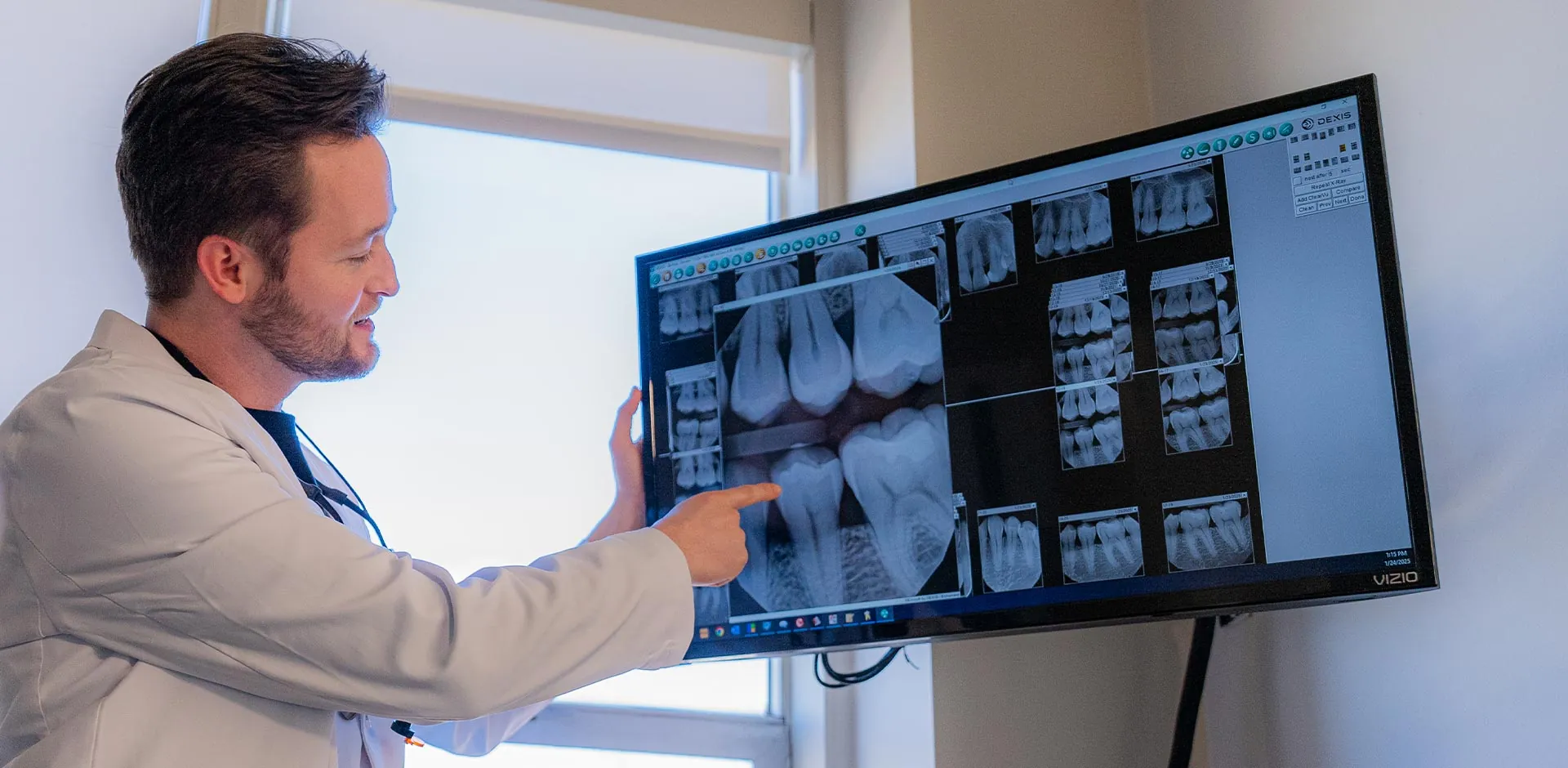 Dr. Moody pointing to a patient's dental x-rays and explaining what they mean