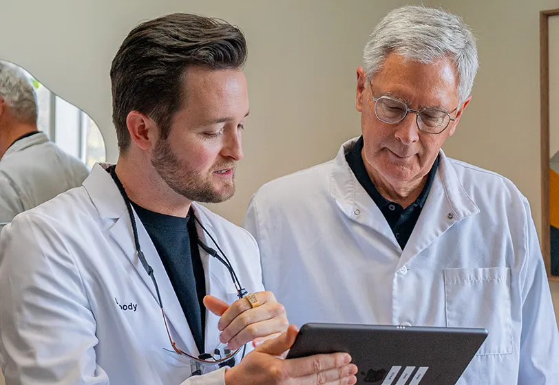 Dr. Moody and Dr. Parket looking at a patient's dental x-ray